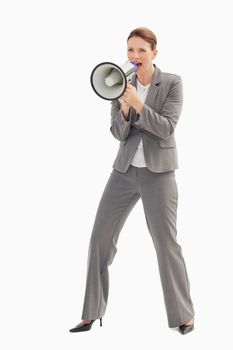 A businesswoman is talking  on a megaphone