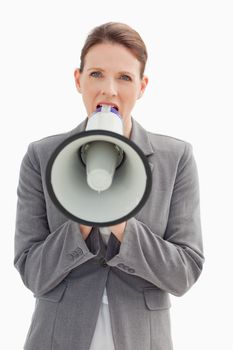 An angry businesswoman shouting into a megaphone