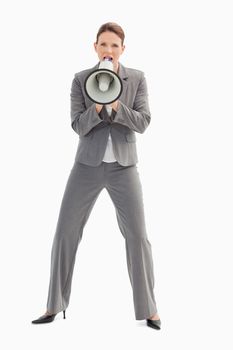 A businesswoman is shouting into a megaphone