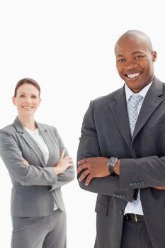 Smiling businessman and woman with their hands folded