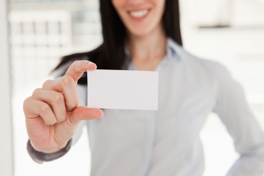 A close up shot of a business card in the hand of a woman 
