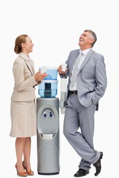 People laughing next to the water dispenser against white background