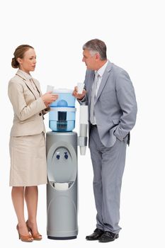 People in suit talking next to the water dispenser against white background
