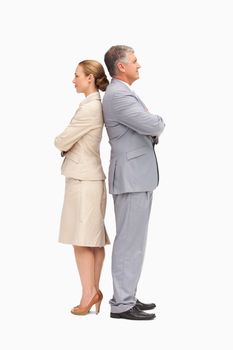 Business people with folded arms back to back against white background