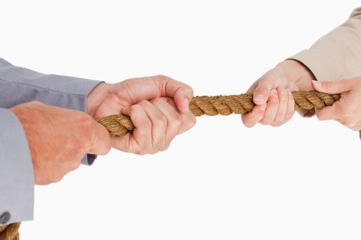 People in suit pulling the rope against white background