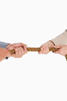 Business people pulling the rope against white background