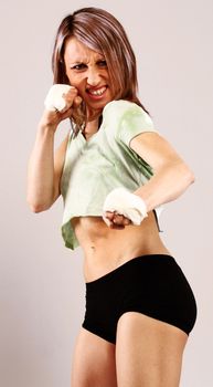 Young woman with aggressive expression that is fighting