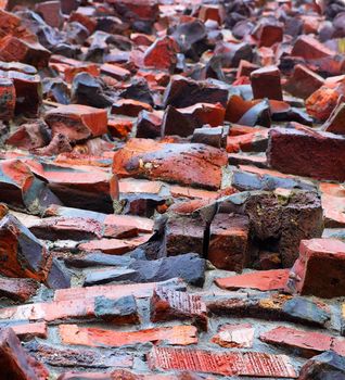 Oddly shaped, fired, and multi-color red  wall of klinker brick from a skewed view