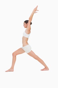 Slim young woman doing yoga against white background