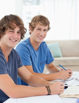 A close up shot of two smiling students as they both look at the camera 