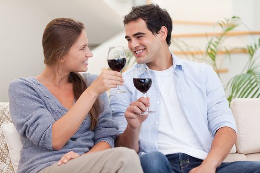 Couple having a glass of wine in their living room