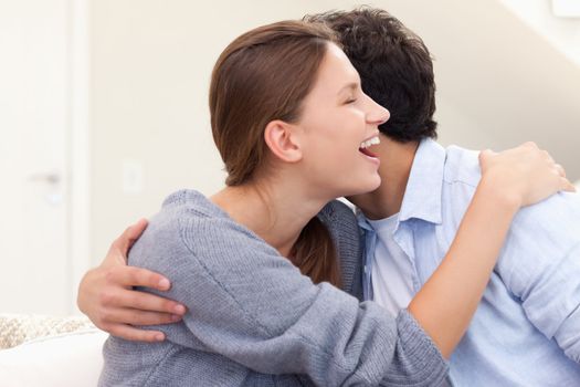 Couple embracing each other in their living room