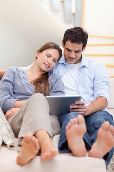 Portrait of a couple using a tablet computer in their living room