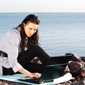 woman with laptop sea background