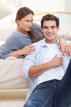 Cute couple hugging in their living room