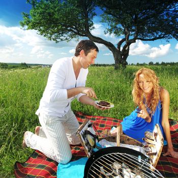 man and woman on picnic in green grass