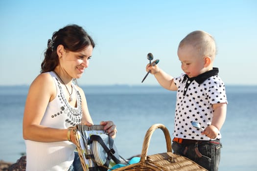 happy mother and son on picnic near sea