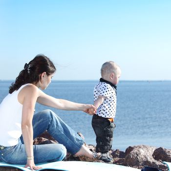 happy mother and son on picnic near sea