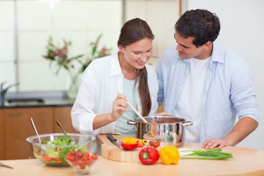 Couple preparing a sauce in their kitchen