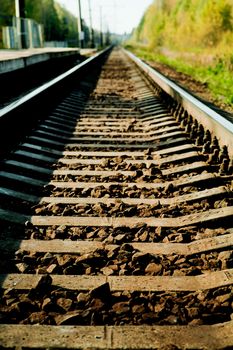 Railway recedes into the distance in a sunny day