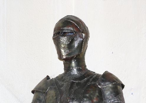 old armour of the medieval knight over gray wall