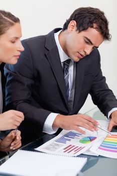 Portrait of a business team studying statistics in a meeting room