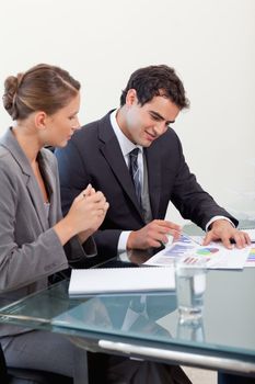 Portrait of a smiling business team studying statistics in a meeting room