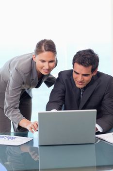 Portrait of a young business team working with a laptop in an office