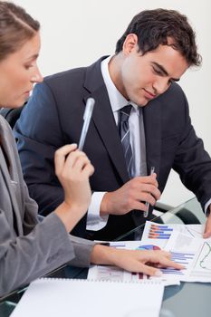 Portrait of a concentrated business team studying statistics in a meeting room