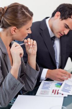 Portrait of a focused business team studying statistics in a meeting room