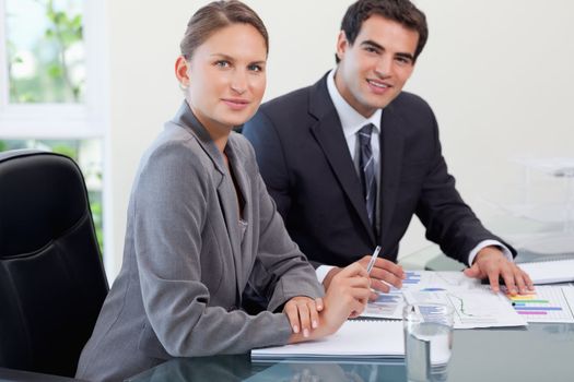 Young business team studying statistics in a meeting room