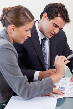 Portrait of a professional business team studying statistics in a meeting room