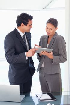 Young business partner looking at tablet in their hands