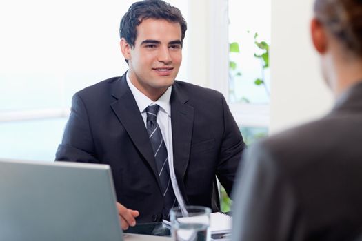 Young manager interviewing a female applicant in his office