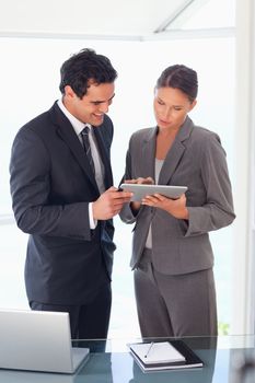 Young business partner looking at tablet together