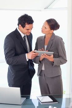 Young business partner working on tablet together