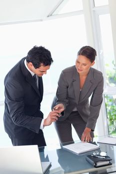 Young businesswoman providing pen to sign contract