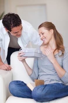 Young woman happy about the gift she just got from her boyfriend