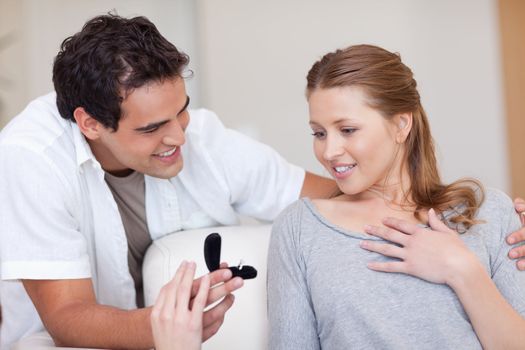 Young man making his girlfriend speechless with proposal