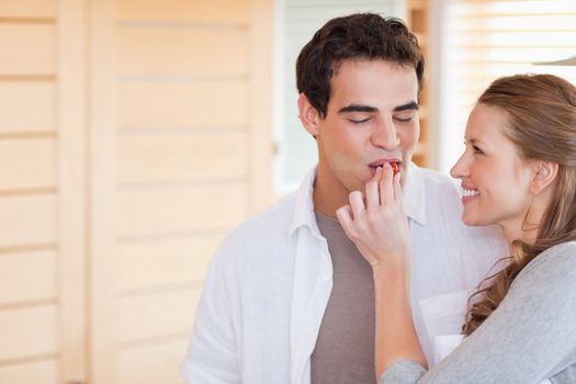 Young woman feeding her boyfriend