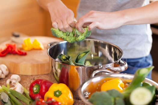 Young woman preparing stew