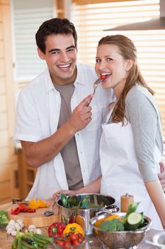 Young couple enjoys preparing lunch together
