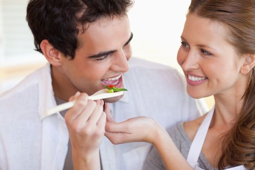 Happy smiling couple enjoys cooking together