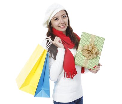 A young woman doing holiday shopping (on white background)