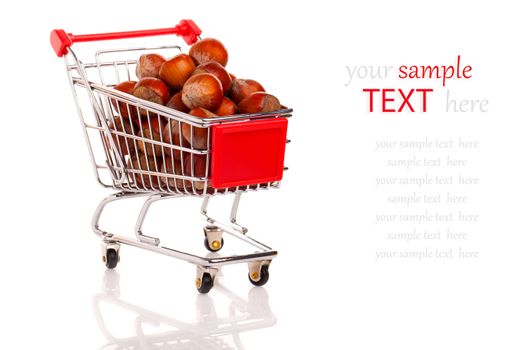 a Shopping cart full of hazelnut, on a white background