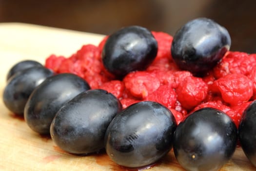 arrangement of wild crushed raspberry and red grapes 