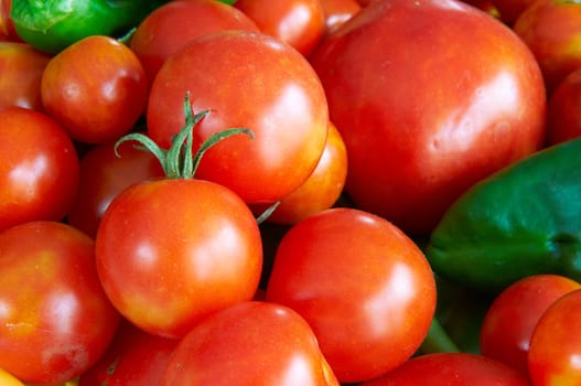 Some tomatoes and peppers in a basket