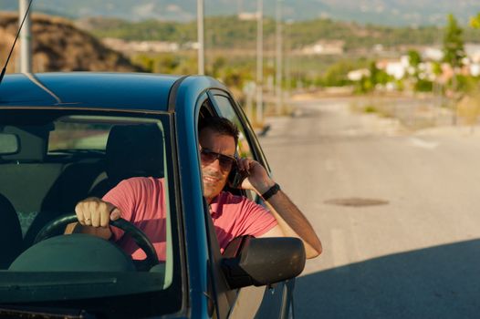 Irresponsible guy using his mobile phone while driving