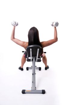 Beautiful young woman lifts hand weights