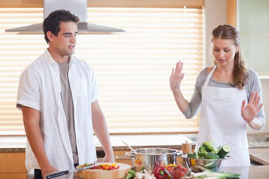 Young couple having a disagreement in the kitchen